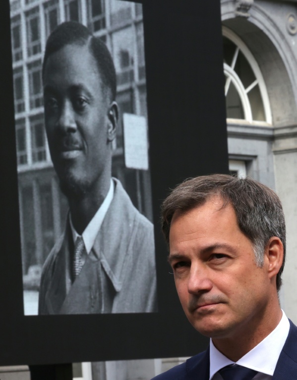 Alexander De Croo, à l'époque Premier ministre belge, devant un portrait géant de Patrice Lumumba, héros de l'indépendance congolaise, arrive au plais d'Egmont pour la restitution d'une dent du dirigeant congolais assassiné, le 20 juin 2022à Bruxelles