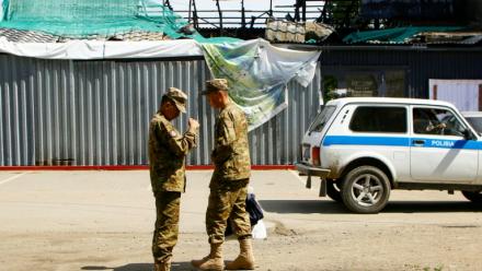 Des soldats devant le bâtiment calciné d'un restaurant après une explosion de gaz survenue en février, le 27 mai 2026 à Chtchoutchinsk, au Kazakhstan
