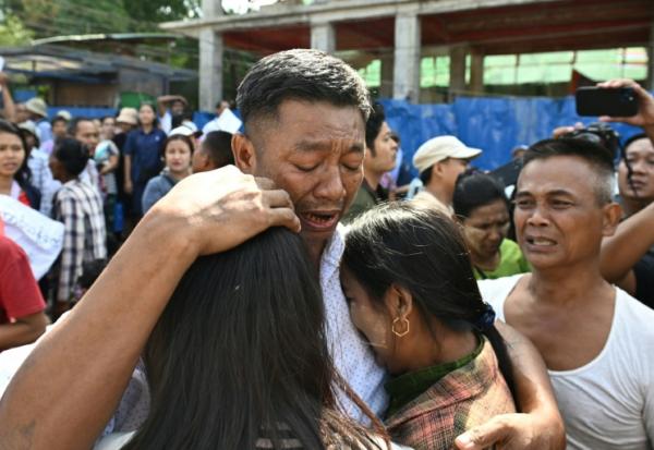 Un prisonnier libéré en Birmanie à la faveur de l'amnistie accordée par la junte à l'occasion de la fête de l'Indépendance retrouve ses proches devant la prison d'Insein, le 4 avril 2026
