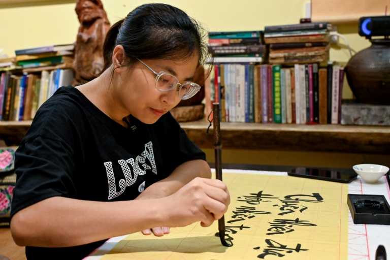 Hoang Thi Thanh Huyen apprend la calligraphie chez le calligraphe Nguyen Thanh Tung, le 15 mai 2025 à Hanoï, au Vietnam