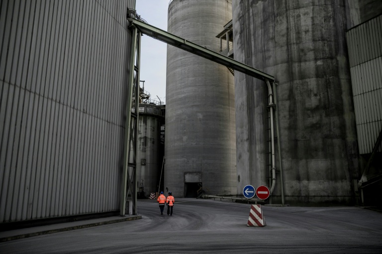 Des employés marchent à l'intérieur de la plus grande cimenterie de France qui appartient au cimentier français Vicat à Montalieu-Vercieu (Isère, sud-est de la France), le 12 novembre 2025