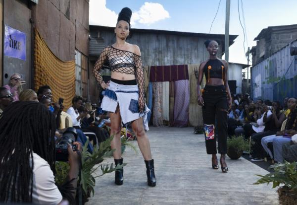 Des mannequins présentent des tenues de créateurs locaux spécialisés dans le recyclage de tissus et de vêtements mis au rebut, lors du défilé de mode Gikomba Runway Edition à Nairobi, le 10 octobre 2025 au Kenya