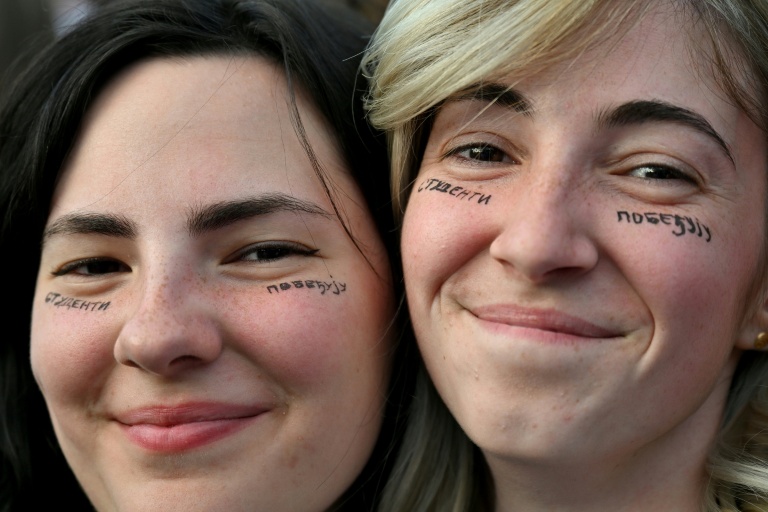 Deux jeunes manifestants avec le slogan 