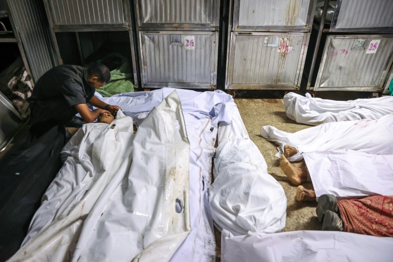 Un Palestinien pleure la mort d'un proche tué la veille par des tirs israéliens alors qu'il venait chercher de l'aide alimentaire, dans la morgue de l'hôpital Al-Shifa de Gaza-ville, le 10 août 2025