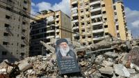 Un portrait du défunt guide suprême iranien Ali Khamenei dans les ruines de bâtiments dans la banlieue sud de Beyrouth, le 6 mai 2026 au Liban