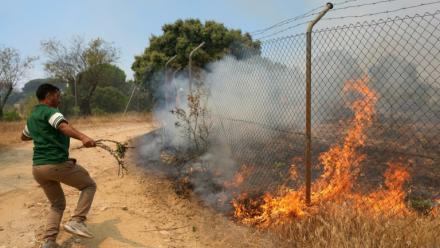 Un habitant essaie d'éteindre un incendie sur sa propriété près de San Martin de Valdeiglesias, à environ 70 km à l'ouest de Madrid, le 26 juillet 2026