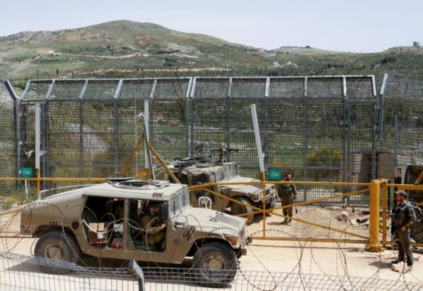 Des soldats israéliens montent la garde près de la barrière frontalière, dans le village de Majdal Shams, sur les hauteurs du Golan annexé, le 30 avril 2025