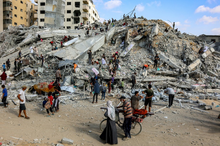 Des Palestiniens fouillent les décombres sur le site de l’effondrement d'une tour d'habitations détruite par un bombardement israélien, dans la ville de Gaza, le 6 septembre 2025