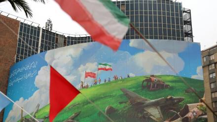 Dans le centre de Téhéran, le drapeau iranien flotte devant un vaste panneau anti-américain, le 8 février 2026