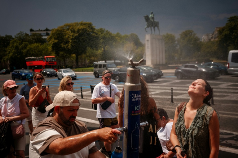 Des personnes se rafraîchissent autour d'une fontaine place du Trocadéro, à Paris, le 26 juin 2026