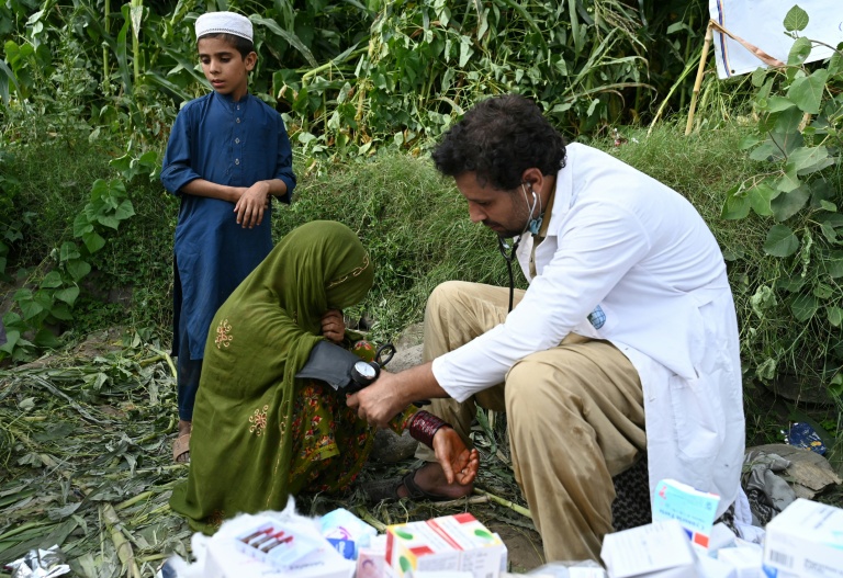 Une femme afghane blessée reçoit des soins médicaux devant une maison endommagée après des tremblements de terre dans le village de Mazar Dara du district de Nurgal, dans la province de Kunar, en Afghanistan oriental, le 1er septembre 2025