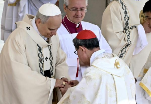 Le cardinal philippin Luis Antonio Gokim Tagle remet l'anneau du pêcheur au doigt du pape Léon XIV lors d'une messe pour le début de son pontificat, sur la place Saint-Pierre au Vatican, le 18 mai 2025.
