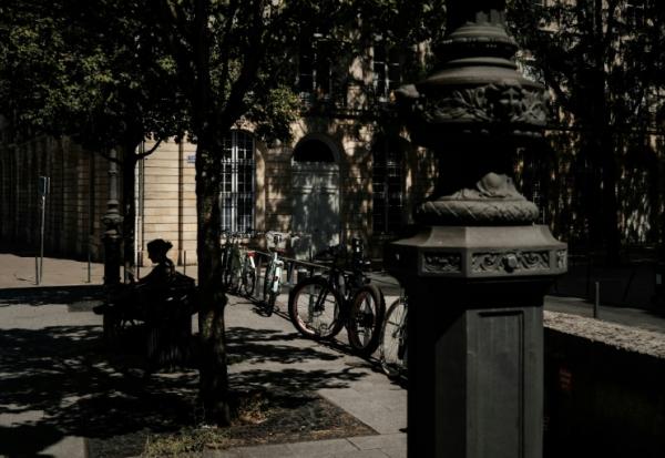 Une femme assise sur un banc à l'ombre à Bordeaux, le 6 juillet 2026 lors d'une vague de chaleur en France