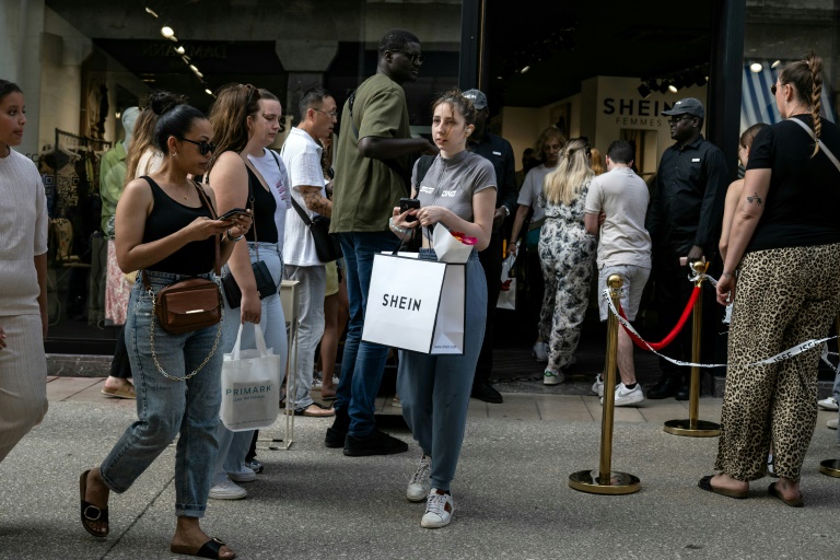 Des cliens quittent une boutique éphémère de Shein à Dijon, le 26 juin 2025