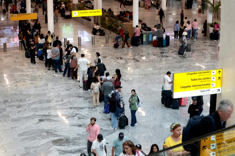 Des passagers attendent dans l'aéroport international de Guadalajara, le 22 février 2026, en raison de l'annulation de vols dus au troubles après la mort du baron de la drogue 