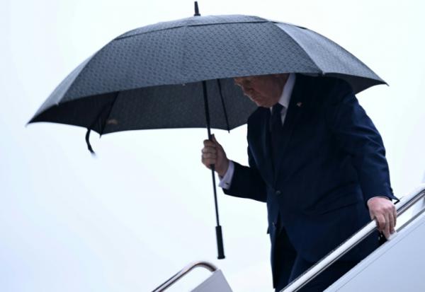 Le président américain Donald Trump tient un parapluie à sa descente de l'avion présidentiel Air Force One à la base Andrews, près de Washington, le 22 mai 2026